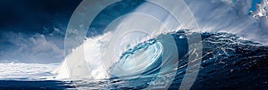 Spectacular colossal ocean wave crashing dramatically with a vibrant blue sky backdrop