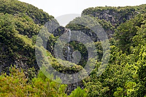 Spectacular double waterfall falling through jungle forest.