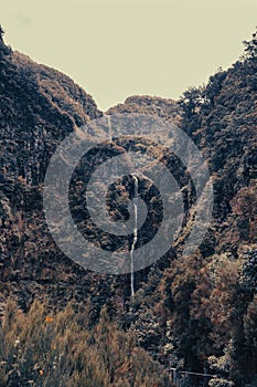 Spectacular double waterfall falling through jungle forest.