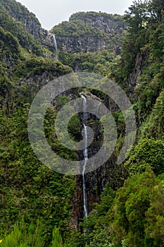 Spectacular double waterfall falling through jungle forest.
