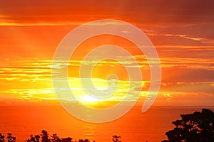 Spectacular dramatic orange sunset over the ocean