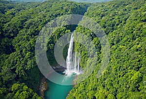 Spectacular drone image of a tropical waterfall surrounded by dense green foliage in a lush forest. AI generated.