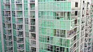 Spectacular drone video of moving down a modern glass apartment residential complex in Los Angeles, California, USA