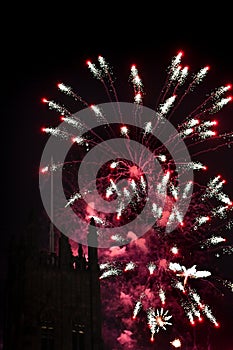 Spectacular fireworks display with a tower in the foreground