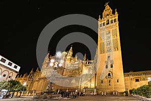 The spectacular and illuminated Cathedral of Seville or Cathedral of Saint Mary of the See and Giralda by night, the world`s