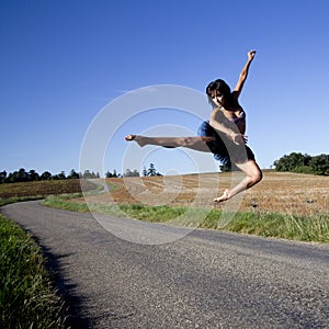 Spectacular jump of a woman over a road.