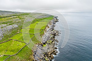 Spectacular misty aerial landscape in the Burren region of County Clare, Ireland. Exposed karst limestone bedrock at the Burren