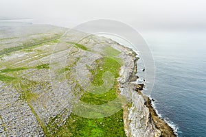 Spectacular misty aerial landscape in the Burren region of County Clare, Ireland. Exposed karst limestone bedrock at the Burren