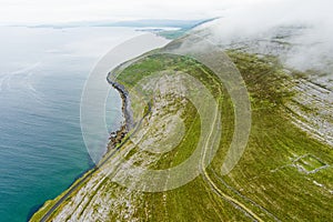 Spectacular misty aerial landscape in the Burren region of County Clare, Ireland. Exposed karst limestone bedrock at the Burren