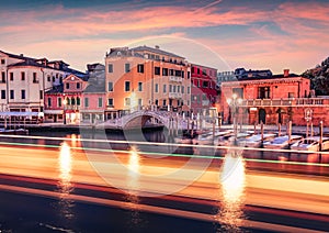 Spectacular morning scene of famous Canal Grande with traces of boat lights.