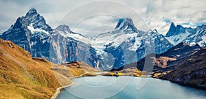 Spectacular morning view of Bachalp lake / Bachalpsee, Switzerland. Wonderful autumn scene of Swiss alps, Grindelwald, Bernese Obe