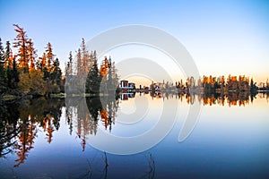 Spectacular Mountain lake Strbske pleso Strbske lake with mirror reflection of trees in lake at sunrise