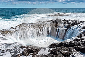 Spectacular natural phenomenon of Bufadero de la Garita where the water goes up and down in the hole with every wave, Gran Canaria photo