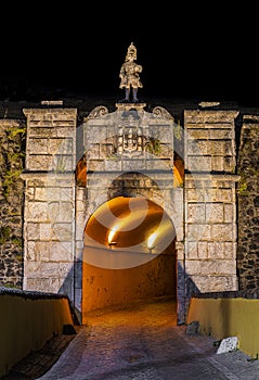 Ornamented gate city entrance of old military fort at night in Elvas, Portugal