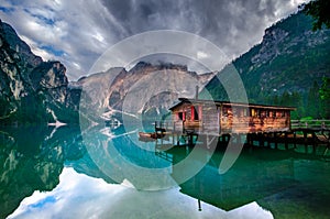 Spectacular romantic place with typical wooden boats on the alpine lake,(Lago di Braies) Braies lake