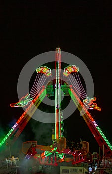 spectacular shot of illuminated fairground ride from below