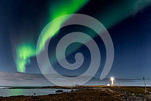 Spectacular show of the Northern Lights over Grotta Island lighthouse in Reykjavic - the capital of Iceland