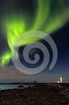 Spectacular show of the Northern Lights over Grotta Island lighthouse in Reykjavic - the capital of Iceland