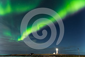 Spectacular show of the Northern Lights over Grotta Island lighthouse in Reykjavic - the capital of Iceland