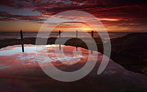 Spectacular sunrise over Ivo Rowe Rockpool Coogee Australia