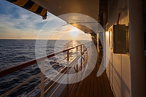 Spectacular sunrise over sea horizon seen from the upper deck of a cruise ship