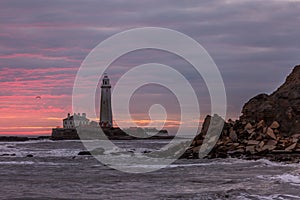 A spectacular sunrise at St Mary`s Lighthouse in Whitley Bay, as the sky erupts in colour