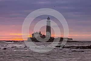 A spectacular sunrise at St Mary`s Lighthouse in Whitley Bay, as the sky erupts in colour