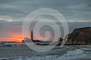 A spectacular sunrise at St Mary`s Lighthouse in Whitley Bay, as the sky erupts in colour