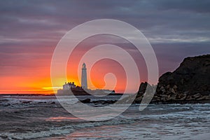A spectacular sunrise at St Mary`s Lighthouse in Whitley Bay, as the sky erupts in colour
