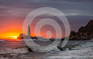 A spectacular sunrise at St Mary`s Lighthouse in Whitley Bay, as the sky erupts in colour