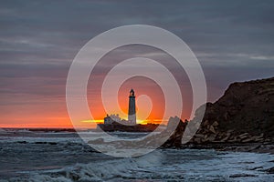 A spectacular sunrise at St Mary`s Lighthouse in Whitley Bay, as the sky erupts in colour