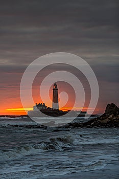A spectacular sunrise at St Mary`s Lighthouse in Whitley Bay, as the sky erupts in colour