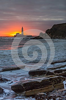 A spectacular sunrise at St Mary`s Lighthouse in Whitley Bay, as the sky erupts in colour photo