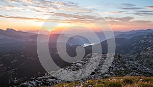 Spectacular sunrise with sun rising above lake Bled as seen from the mountains.