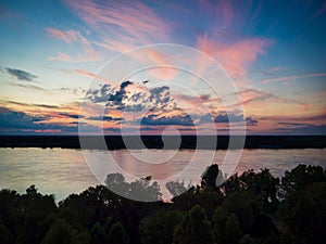 Spectacular sunset above Mississippi river near Natchez with clouds and reflections in water