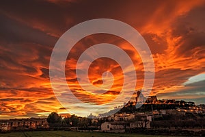 Spectacular sunset with lenticular clouds above a medieval castle in Caravaca de la Cruz, province of Murcia. Spain