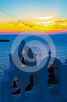 Spectacular sunset view and church belfry Oia Santorini Greece