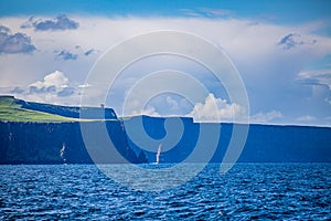 Spectacular view of the Cliffs of Moher and the Branaunmore sea stack, seen from a boat