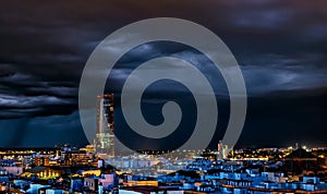 Spectacular view of Historic Triana Neighborhood and Seville city skyline a stormy night. Seville city, Tradition and Modernity