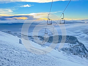 Spectacular view of the morning sky and ungroomed slopes of a closed ski resort. photo