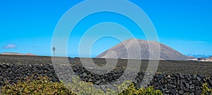 Panoramic view of mountain range with volcanoes in Timanfaya National Park. Cloudless blue sky. Lanzarote, Canary Islands