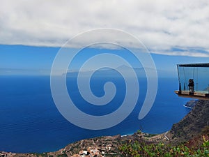 Spectacular views of the Teide Volcano with clouds and a lookout walkway suspended over the sea. Abrante viewpoint on the island