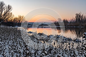 A spectacular winter sunset landscape in the Russian countryside with waterfront. Surroundings of Taganrog