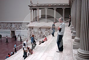 Spectators on the steps of the Pergamon Altar in Pergamon Museum, Berlin, Germany