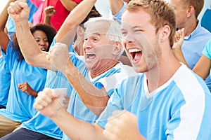 Spectators In Team Colors Watching Sports Event