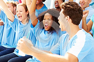 Spectators In Team Colors Watching Sports Event