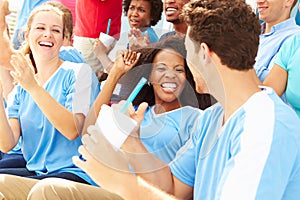 Spectators In Team Colors Watching Sports Event