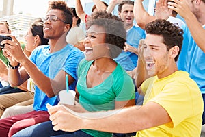 Spectators In Team Colors Watching Sports Event