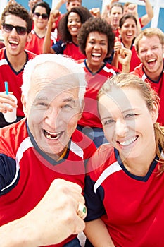 Spectators In Team Colors Watching Sports Event