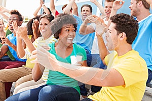 Spectators In Team Colors Watching Sports Event